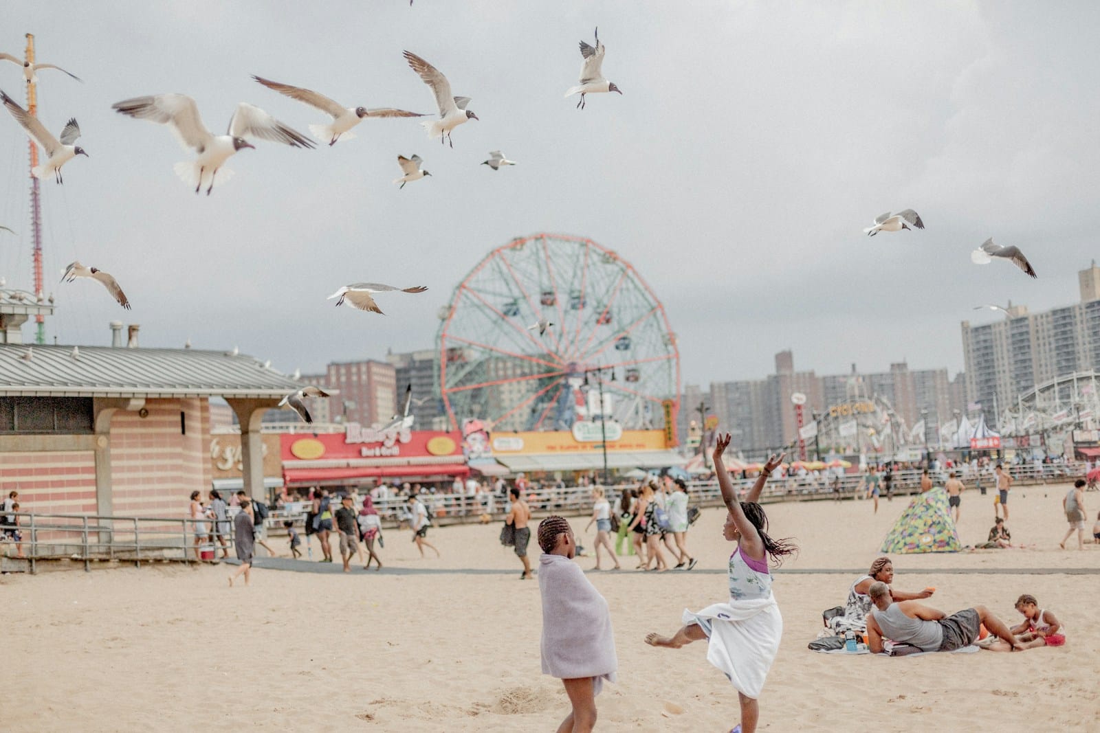 Photo by Brian Kyed Plage animée, enfants, mouettes volantes, grande roue.